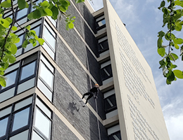Photo of a group of someone abseiling down the Hallam Uni building