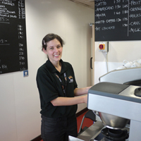 Photo of cafe staff member making coffee