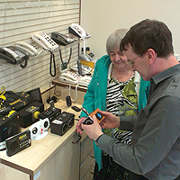Photograph of client in Equipment Centre with SRSB staff