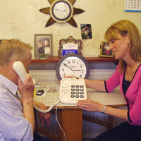 Photograph of one of SRSB’s Community Advice Officers with a client discussing equipment
