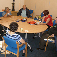 Photograph of clients discussing a book