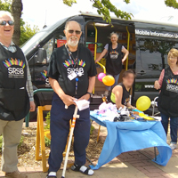 Photo of some volunteers at an outdoor collection in front of the mobile information unit