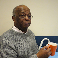 Photograph of one of SRSBs clients drinking a cup of tea