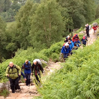Photo of the group walking up a hilly path