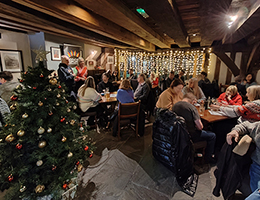 Photo of participants in the decorated pub at 2023 pub quiz