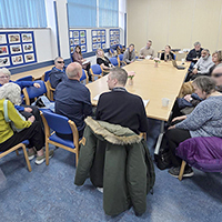 People in the meeting sitting around a table