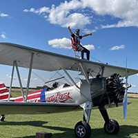 Photo of someone on top of a small plane