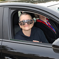 Someone behind the wheel of a car wearing simulation specs