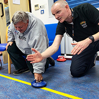 Photo of some people playing curling