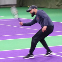 Photo of Nomaan playing tennis