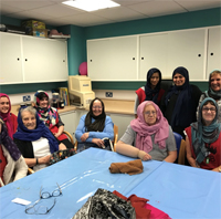 Photograph of SRSB client, volunteers and staff wearing headscarves