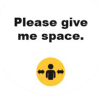 Photo of an illustration saying Please Give Me Space with a yellow symbol that has a picture of a person with an arrow on either side of them indicating space