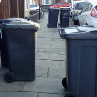 Photo of some bins across a pavement