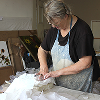 Photo of Cath sculpting in a studio