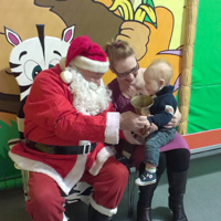 Photograph of child with mum and santa